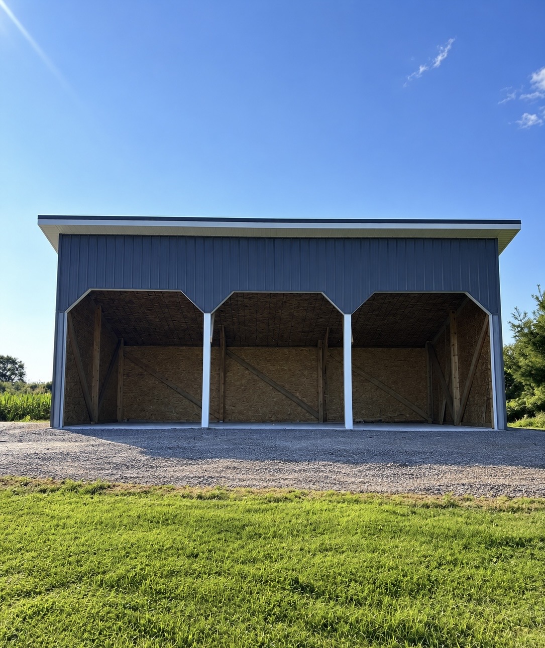 Finished metal-clad pole barn with three open bays