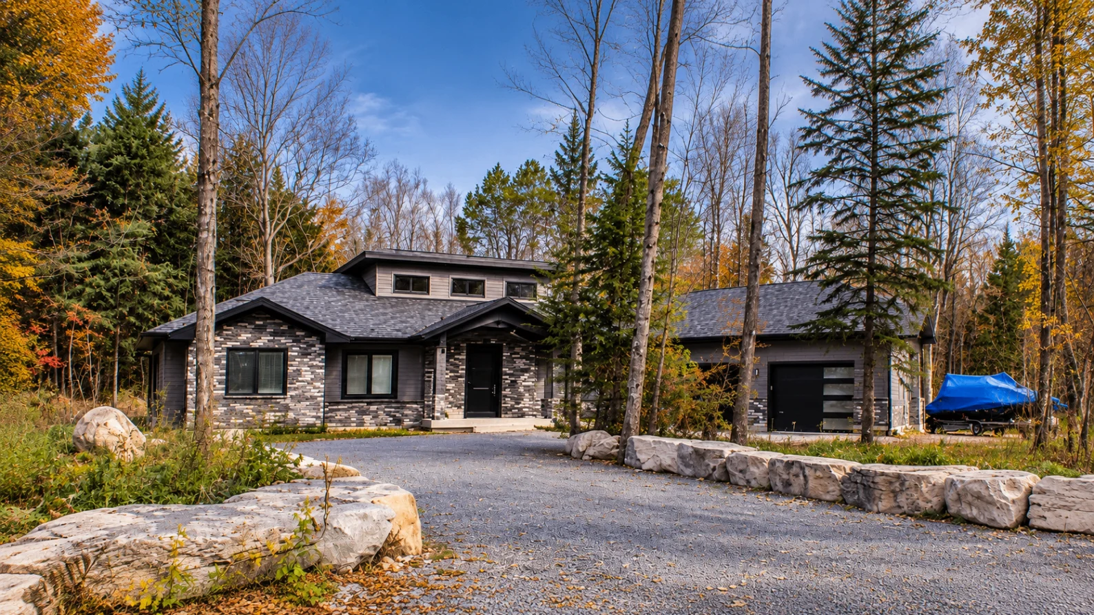 Stone-clad modern residence in an autumn woodland